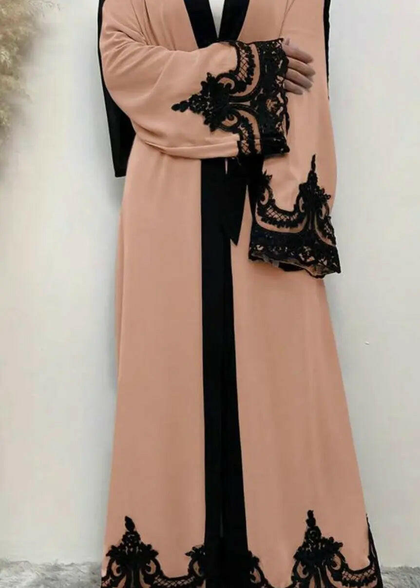 WOMAN WEARING PINK AND BLACK ABAYA 2025